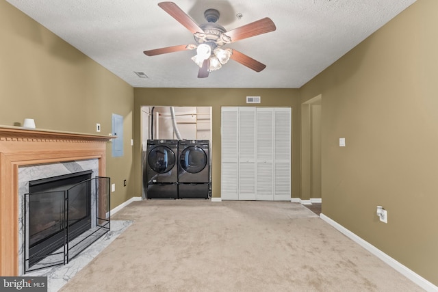 5522 Trout Run Rd, Clinton, MD 20735 - unfurnished living room with independent washer and dryer, carpet floors, a ceiling fan, and a fireplace