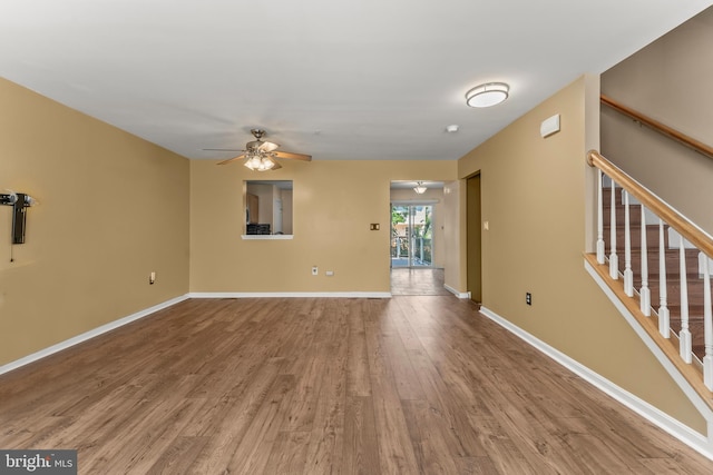 5522 Trout Run Rd, Clinton, MD 20735 - empty room with wood finished floors, a ceiling fan, and stairway