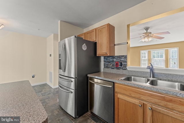 5522 Trout Run Rd, Clinton, MD 20735 - kitchen featuring stainless steel appliances, dark stone finish flooring, a ceiling fan, and tasteful backsplash
