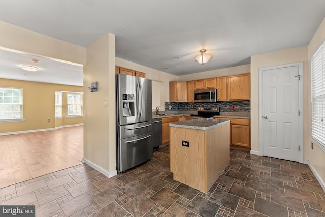 5522 Trout Run Rd, Clinton, MD 20735 - kitchen with stainless steel appliances, decorative backsplash, open floor plan, a center island, and dark stone finish flooring