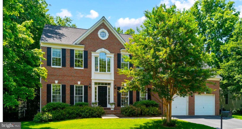 47236 Middle Bluff Pl, Sterling, VA 20165 - georgian-style home featuring brick siding, asphalt driveway, a front lawn, and a garage