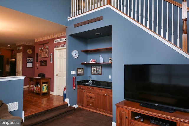 2553 Stone Hill Rd, Harleysville, PA 19438 - living area featuring wet bar, stairs, and dark carpet