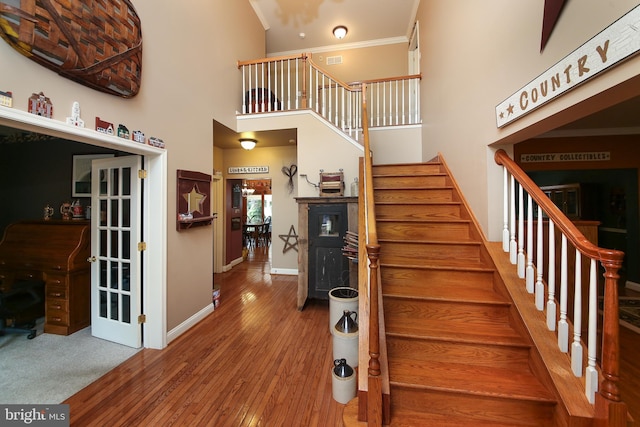 2553 Stone Hill Rd, Harleysville, PA 19438 - stairway with hardwood / wood-style flooring, a high ceiling, and crown molding