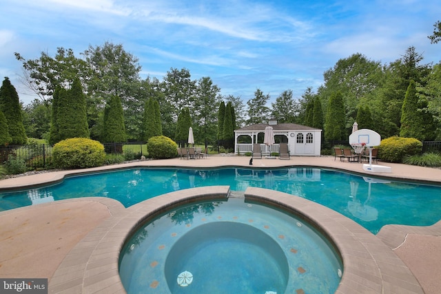 2553 Stone Hill Rd, Harleysville, PA 19438 - view of pool featuring a pool with connected hot tub, a patio area, and an outbuilding