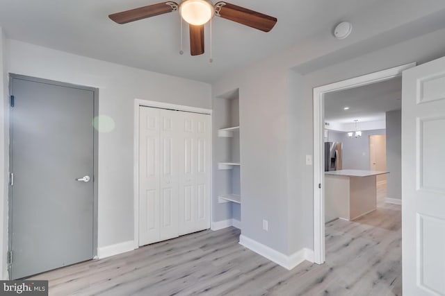 537 Newcomb St SE, Washington, DC 20032 - unfurnished bedroom with light wood finished floors, stainless steel refrigerator with ice dispenser, a closet, and ceiling fan
