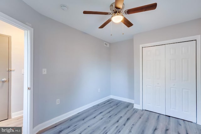537 Newcomb St SE, Washington, DC 20032 - unfurnished bedroom with light wood finished floors, a closet, and a ceiling fan