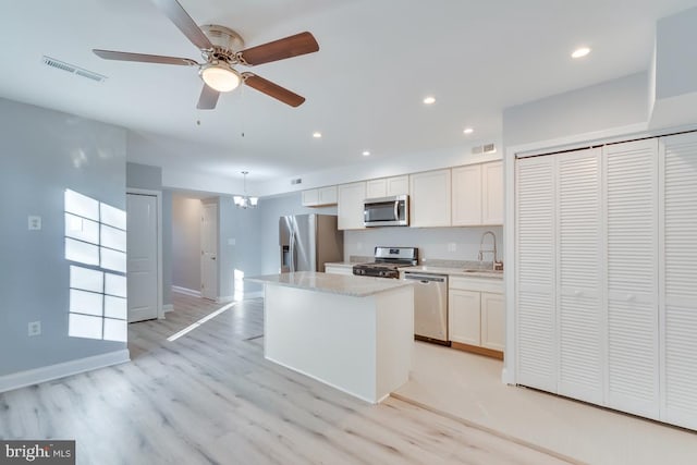 537 Newcomb St SE, Washington, DC 20032 - kitchen with stainless steel appliances, a kitchen island, recessed lighting, light wood-style floors, and ceiling fan