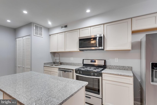 537 Newcomb St SE, Washington, DC 20032 - kitchen featuring stainless steel appliances, recessed lighting, light countertops, and a kitchen island
