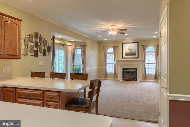 395 Olde Meadow Ln, Lebanon, PA 17042 - kitchen with light countertops, ceiling fan, recessed lighting, brown cabinetry, and a peninsula