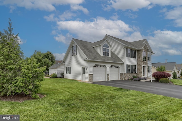 395 Olde Meadow Ln, Lebanon, PA 17042 - view of front facade with stone siding, asphalt driveway, a shingled roof, a front yard, and a garage