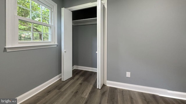 519 Clarks Run Rd, La Plata, MD 20646 - unfurnished bedroom with dark wood-type flooring, multiple windows, and a closet