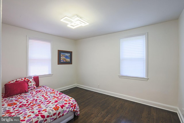 6203 Hopeton Ave, Baltimore, MD 21215 - bedroom with baseboards and dark wood finished floors