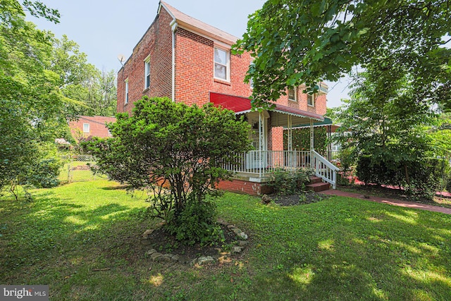 6203 Hopeton Ave, Baltimore, MD 21215 - rear view of property featuring brick siding and a porch