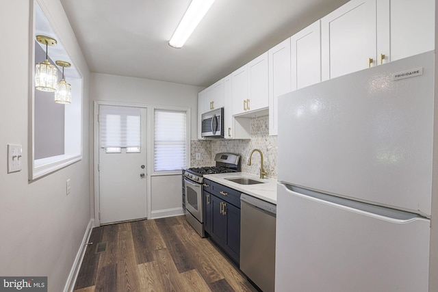 6203 Hopeton Ave, Baltimore, MD 21215 - kitchen with stainless steel appliances, dark wood-style floors, decorative backsplash, white cabinets, and light countertops