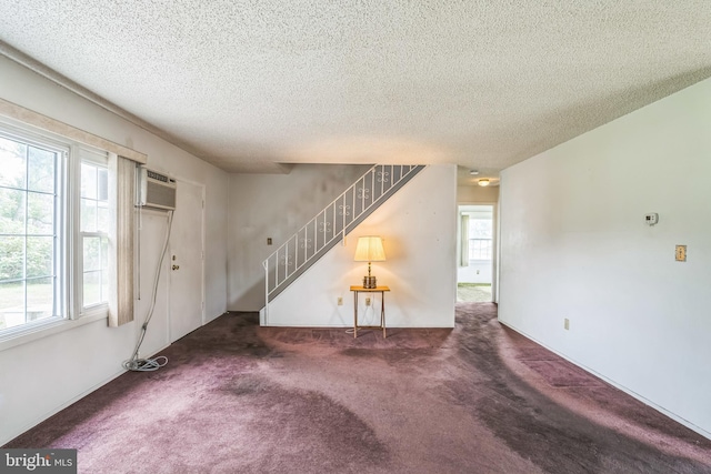 19 Marblestone Ln, Willingboro, NJ 08046 - unfurnished living room featuring stairway, a textured ceiling, carpet flooring, and an AC wall unit