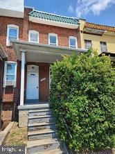 2622 W Franklin St, Baltimore, MD 21223 - view of property with brick siding and a tile roof