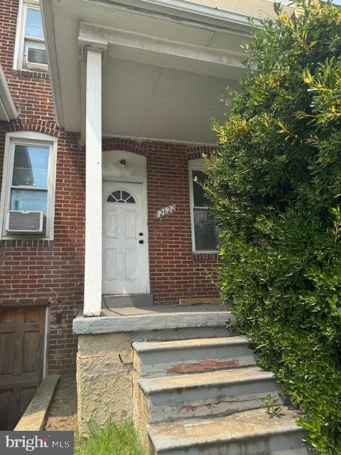 2622 W Franklin St, Baltimore, MD 21223 - view of exterior entry with brick siding and cooling unit