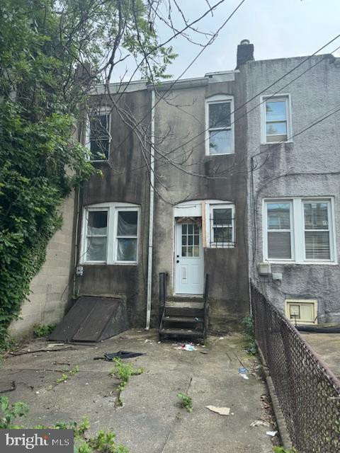 2622 W Franklin St, Baltimore, MD 21223 - view of front of house with entry steps and stucco siding