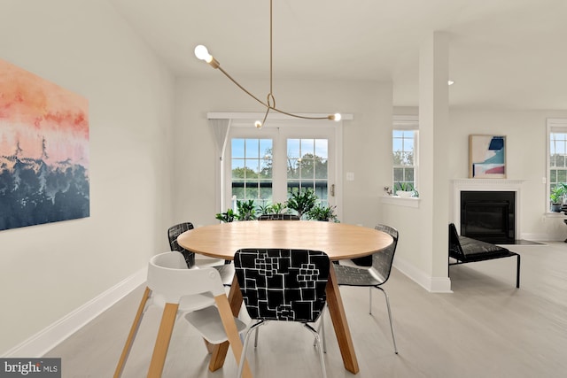 22974 Weybridge Sq, Broadlands, VA 20148 - dining space featuring light wood-style floors and a fireplace with flush hearth