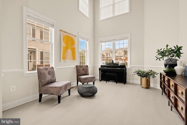 22974 Weybridge Sq, Broadlands, VA 20148 - living area featuring a high ceiling and wood finished floors