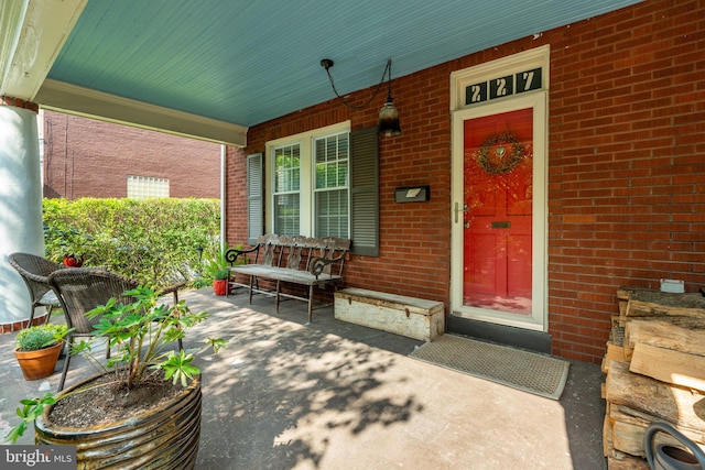 227 Ruby St, Lancaster, PA 17603 - doorway to property featuring covered porch and brick siding