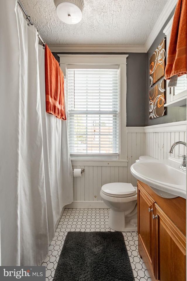 227 Ruby St, Lancaster, PA 17603 - full bathroom with wainscoting, vanity, ornamental molding, a shower with shower curtain, and tile patterned floors