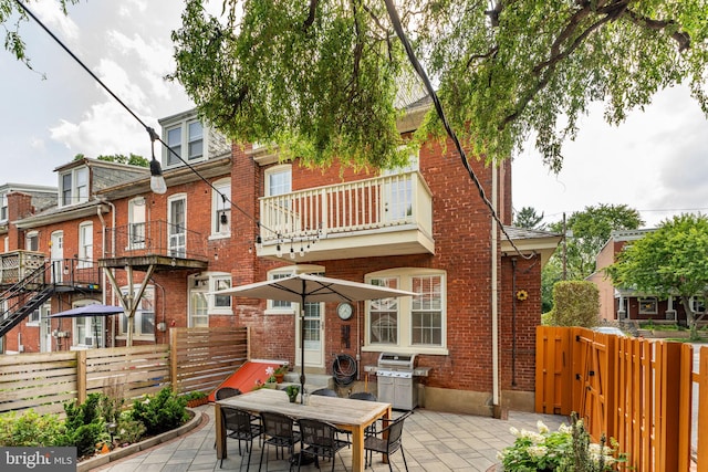 227 Ruby St, Lancaster, PA 17603 - back of property featuring brick siding, a fenced backyard, a patio area, and a balcony