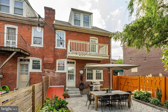 227 Ruby St, Lancaster, PA 17603 - rear view of property featuring a balcony, entry steps, a fenced backyard, a patio, and brick siding