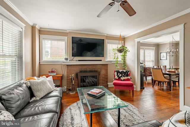 227 Ruby St, Lancaster, PA 17603 - living area featuring hardwood / wood-style floors, a ceiling fan, crown molding, a chandelier, and a brick fireplace