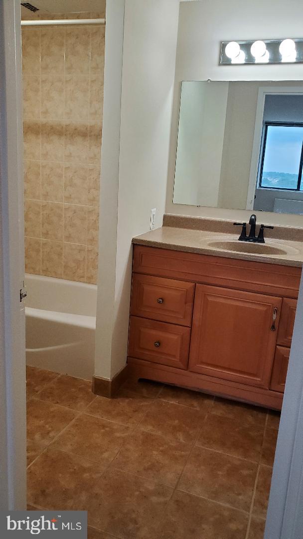 3705 S George Mason Dr Unit 1311, Falls Church, VA 22041 - bathroom featuring vanity, tile patterned floors, and washtub / shower combination