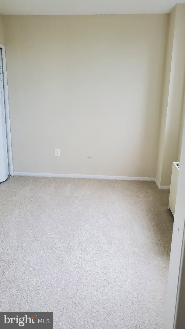 3705 S George Mason Dr Unit 1311, Falls Church, VA 22041 - carpeted empty room featuring baseboards