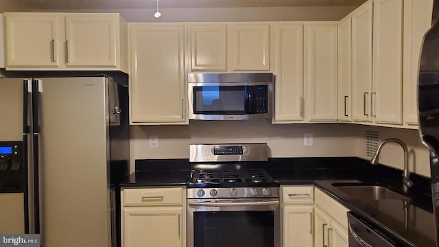 3705 S George Mason Dr Unit 1311, Falls Church, VA 22041 - kitchen with appliances with stainless steel finishes, white cabinets, and dark countertops