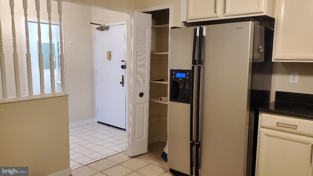 3705 S George Mason Dr Unit 1311, Falls Church, VA 22041 - kitchen with refrigerator with ice dispenser, light tile patterned floors, dark countertops, and white cabinets