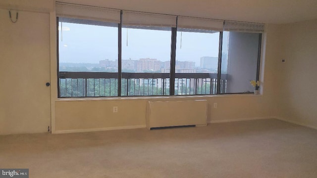 3705 S George Mason Dr Unit 1311, Falls Church, VA 22041 - carpeted spare room featuring radiator heating unit and a view of city