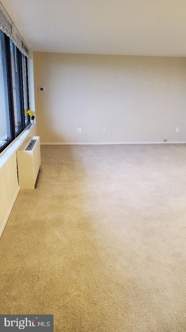 3705 S George Mason Dr Unit 1311, Falls Church, VA 22041 - carpeted spare room with radiator heating unit and baseboards