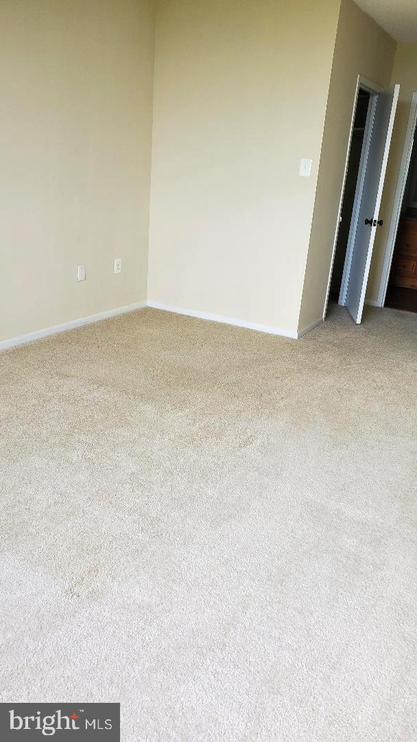 3705 S George Mason Dr Unit 1311, Falls Church, VA 22041 - spare room featuring light carpet and baseboards
