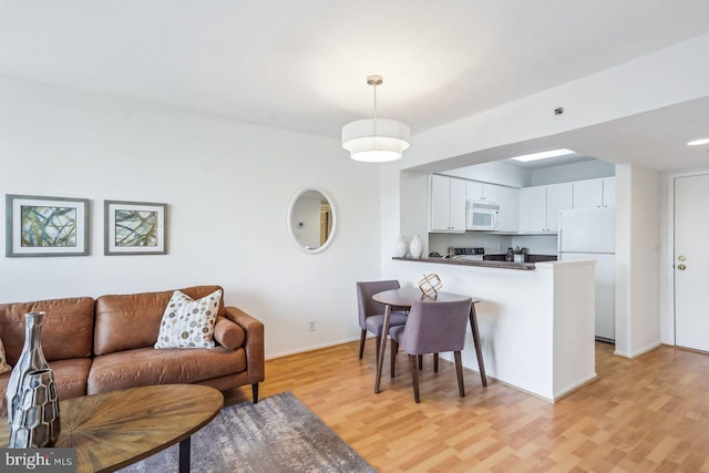 1401 17th St NW Unit 610, Washington, DC 20036 - living area with light wood-style floors and baseboards