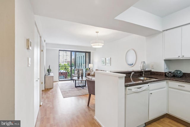 1401 17th St NW Unit 610, Washington, DC 20036 - kitchen featuring dishwasher, a peninsula, white cabinetry, light wood-style floors, and open floor plan