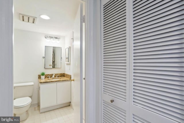 1401 17th St NW Unit 610, Washington, DC 20036 - bathroom with a closet, vanity, tile patterned flooring, and recessed lighting