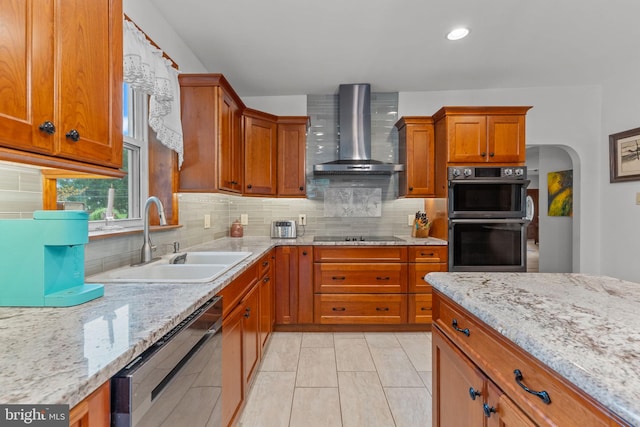 352 Concord Rd, Glen Mills, PA 19342 - kitchen featuring wall chimney exhaust hood, dishwashing machine, stainless steel double oven, brown cabinetry, and backsplash