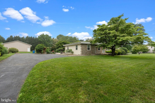 352 Concord Rd, Glen Mills, PA 19342 - view of property exterior featuring a lawn, stone siding, and asphalt driveway