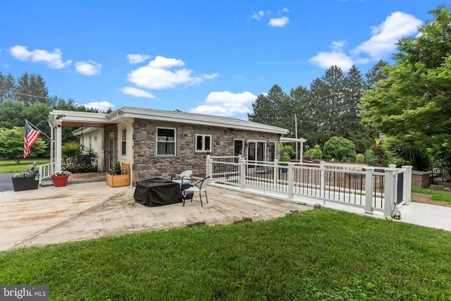 352 Concord Rd, Glen Mills, PA 19342 - back of property featuring a patio, stone siding, and a lawn