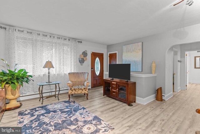 352 Concord Rd, Glen Mills, PA 19342 - living area featuring arched walkways, wood finished floors, baseboard heating, and a baseboard radiator