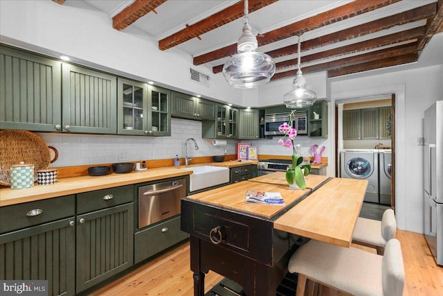 67 W Ferry St, New Hope, PA 18938 - kitchen featuring green cabinets, washing machine and dryer, butcher block counters, appliances with stainless steel finishes, and light wood finished floors