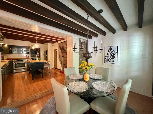 67 W Ferry St, New Hope, PA 18938 - dining room featuring beam ceiling, stairs, and wood finished floors