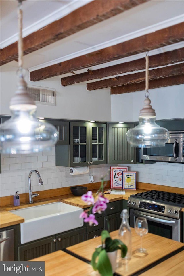 67 W Ferry St, New Hope, PA 18938 - kitchen with stainless steel appliances, wooden counters, tasteful backsplash, beam ceiling, and glass insert cabinets