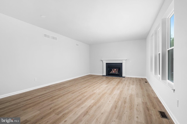 4913 S Broad St, Hamilton, NJ 08620 - unfurnished living room with light wood-style flooring and a fireplace with flush hearth
