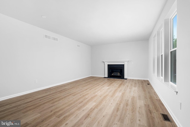 4913 S Broad St, Hamilton, NJ 08620 - unfurnished living room featuring light wood finished floors and a fireplace with flush hearth