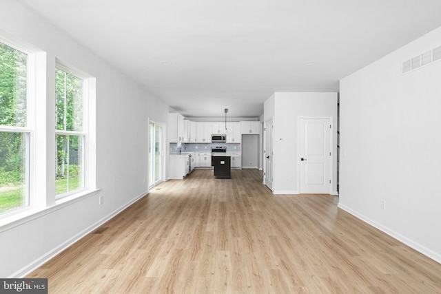 4913 S Broad St, Hamilton, NJ 08620 - unfurnished living room with light wood-type flooring and baseboards