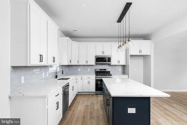 4913 S Broad St, Hamilton, NJ 08620 - kitchen with stainless steel appliances, white cabinets, tasteful backsplash, light wood-style floors, and recessed lighting